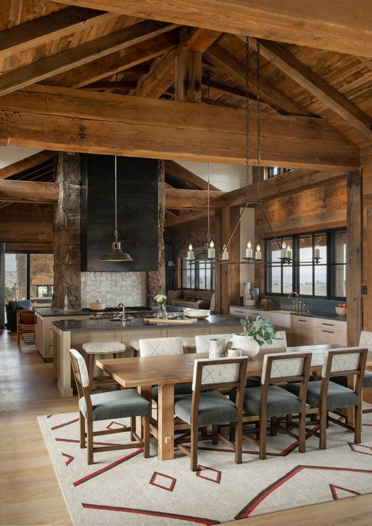 A dining room with a table and chairs and a rug
