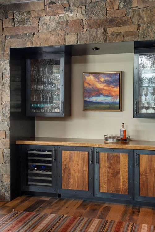 A kitchen with wooden cabinets and a painting on the wall.