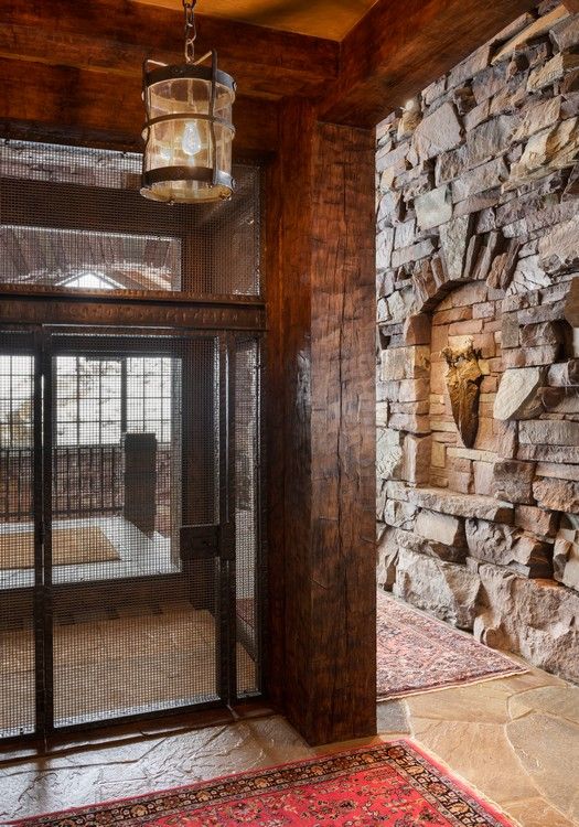 A room with a cage and a stone wall.