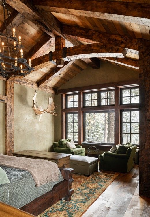 A bedroom with a large bed and lots of windows