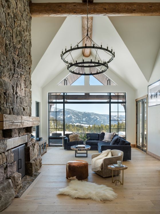 A living room with a fireplace and a large window