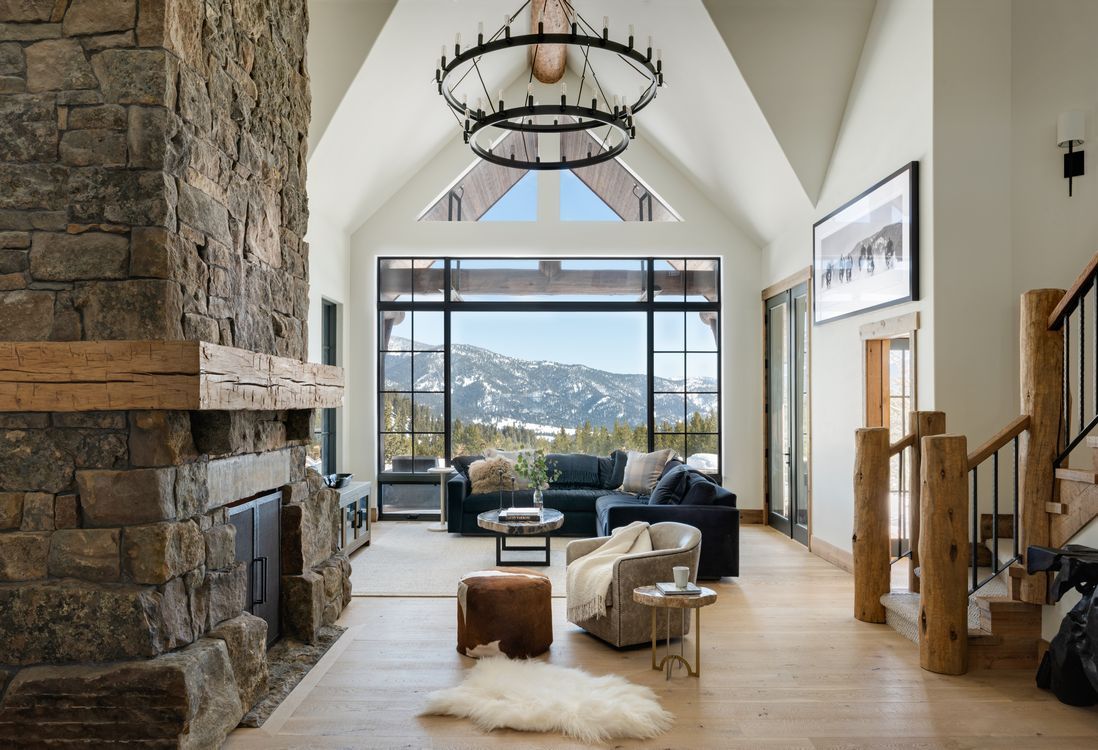 A living room with a fireplace and a large window