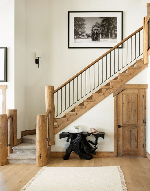 A wooden staircase with a picture on the wall above it