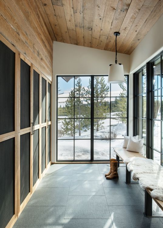 A boot is sitting on a bench in a room with lots of windows