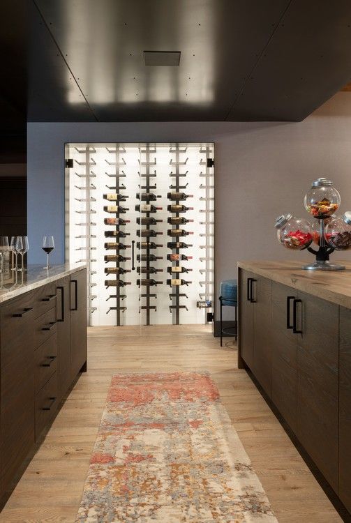 A kitchen with a long hallway leading to a wine cellar.