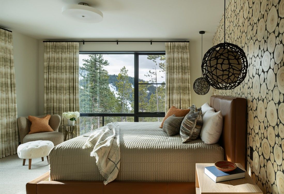 A bedroom with a large bed and a large window.