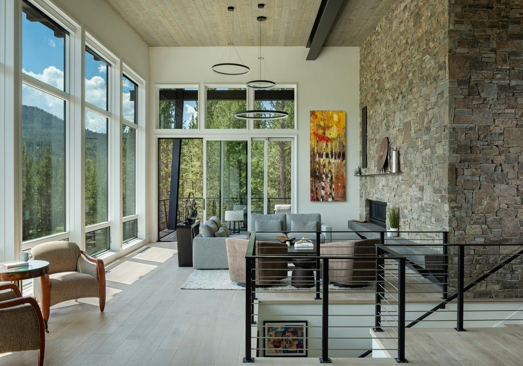 A living room with a lot of windows and a fireplace.
