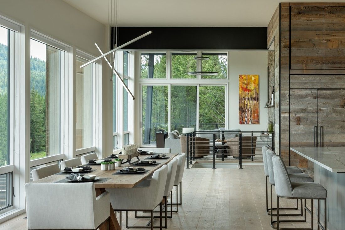 There is a dining table and chairs in the middle of the room.