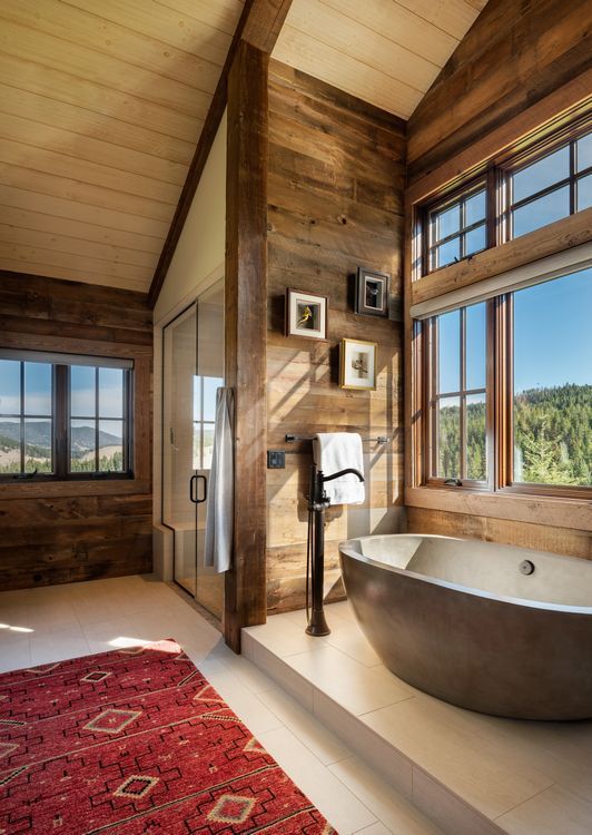A bathroom with a large tub and a large window