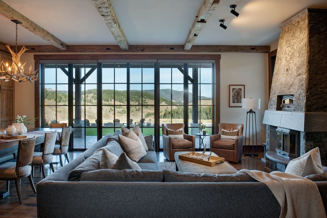 A living room with a large couch and a fireplace