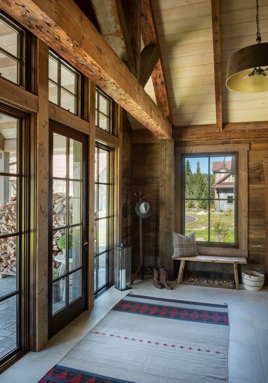 A room with a lot of windows and wooden beams