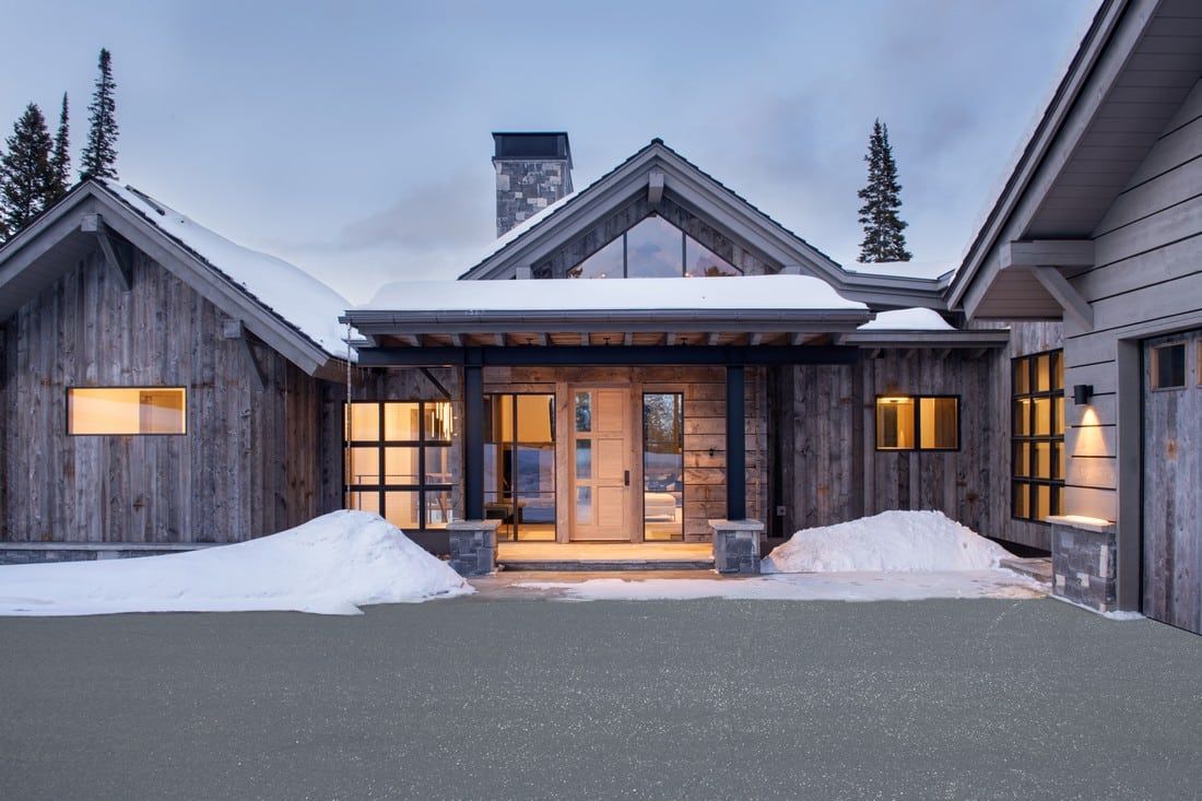 A large house with a lot of snow on the ground