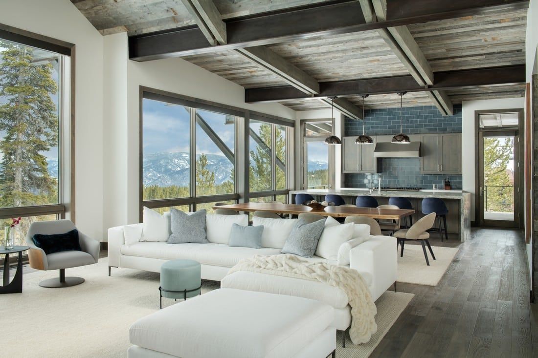 A living room filled with furniture and a lot of windows.