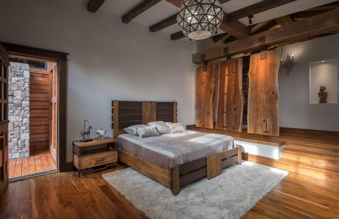 A bedroom with a bed , nightstand , and sliding barn doors.