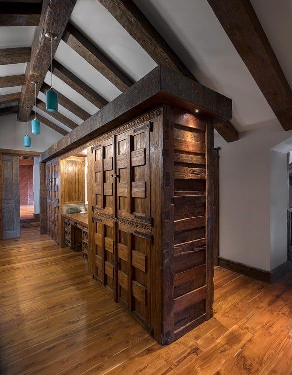 A hallway with hardwood floors and wooden walls