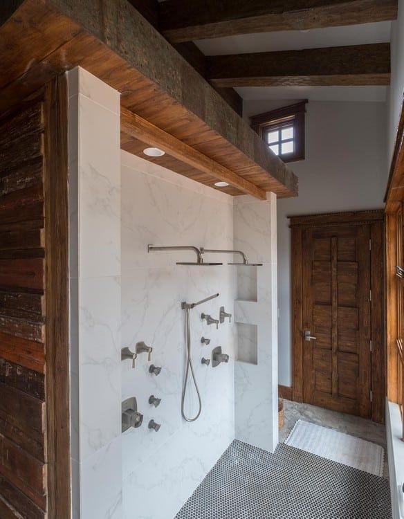 A bathroom with a walk in shower and a window