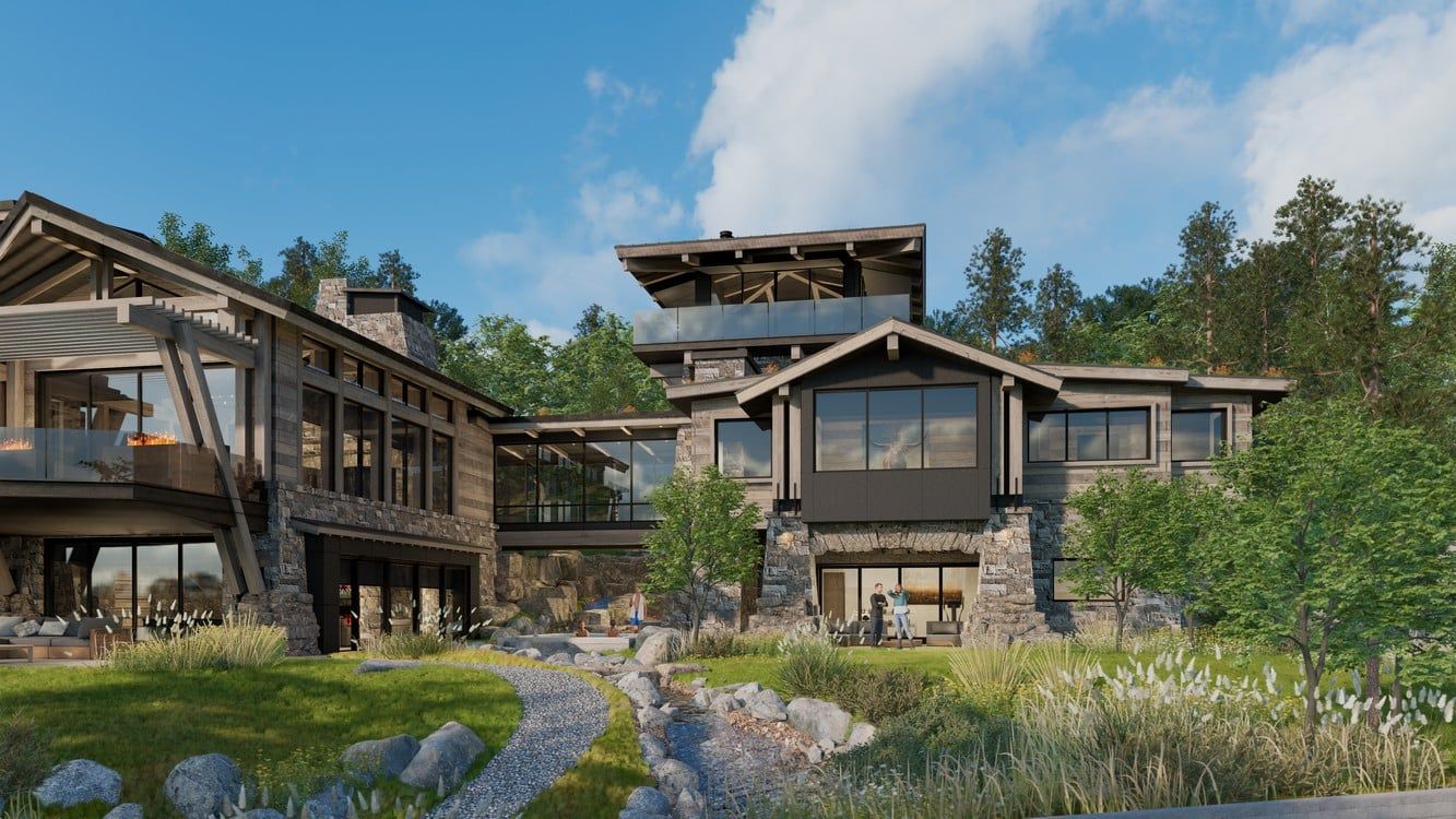 A large house with a lot of windows is surrounded by trees and grass.