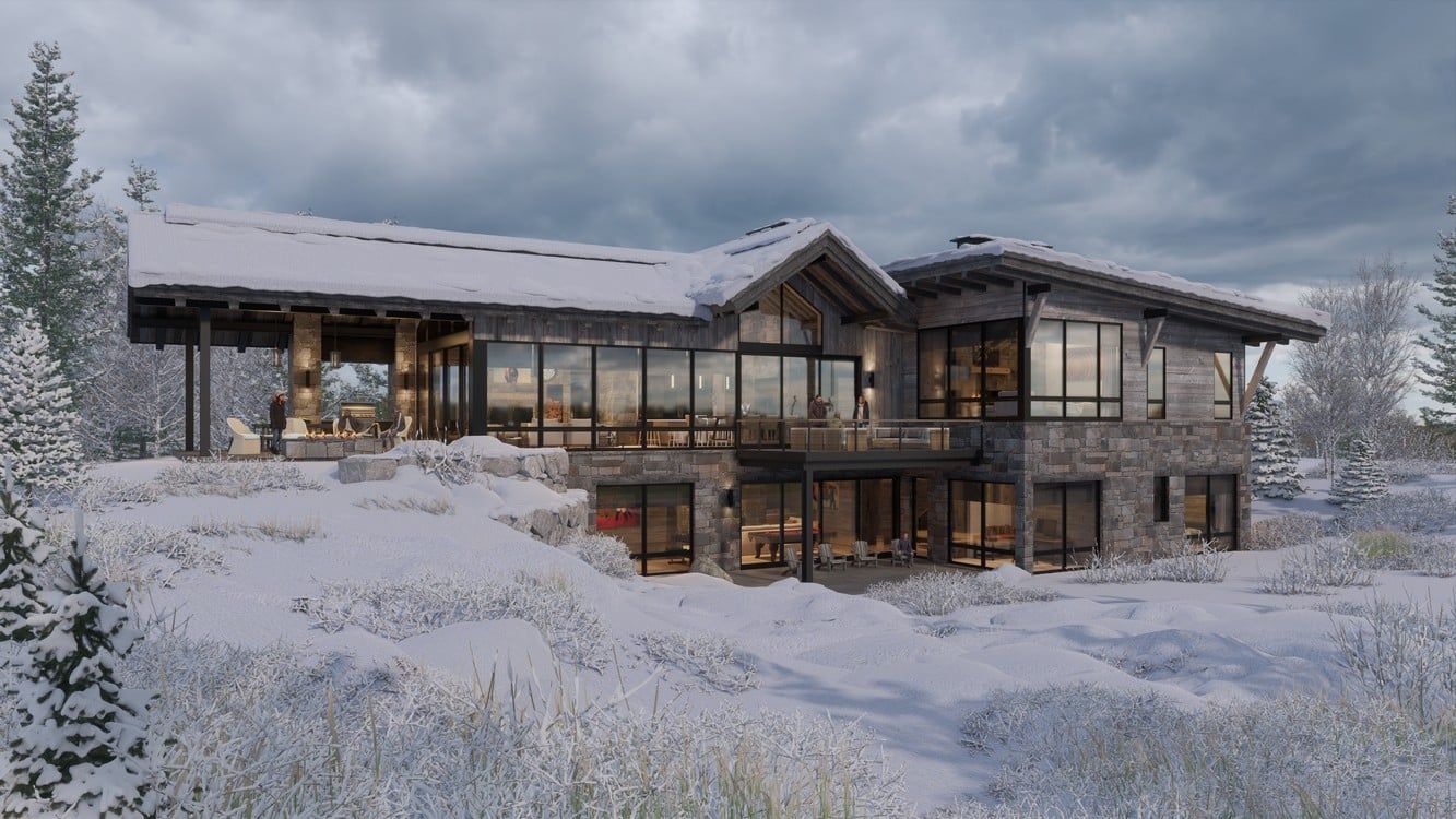 A large house with a lot of windows is surrounded by snow and trees.