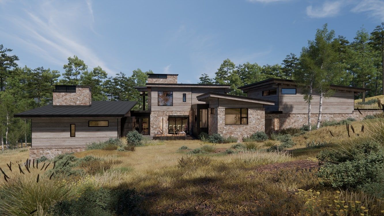 A large house is sitting on top of a hill in the middle of a field surrounded by trees.