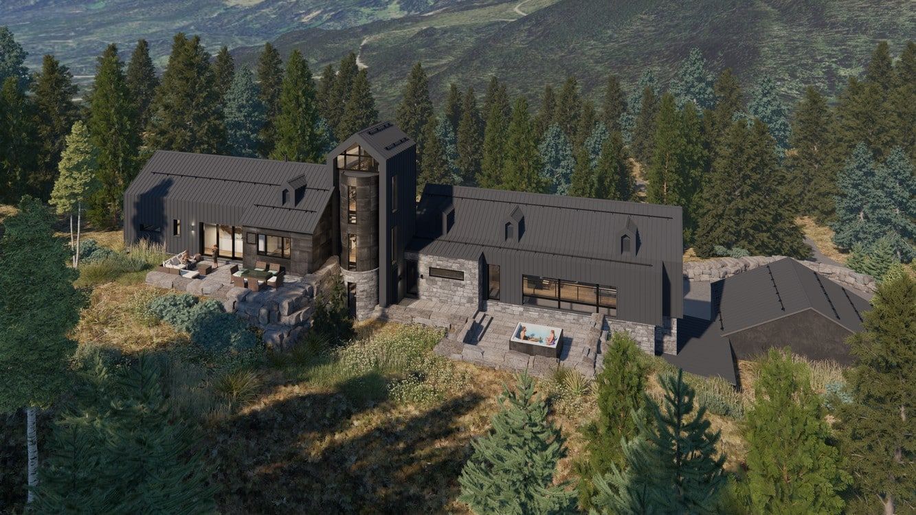 An aerial view of a large house in the middle of a forest.