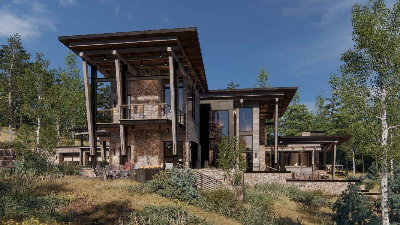 A large house is sitting on top of a hill in the middle of a forest.