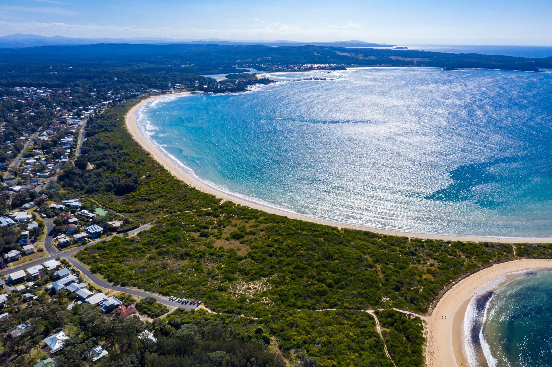 Aerial View of A Crescent Beach with Turquoise Water — Eurobodalla Windscreens in Broulee, NSW