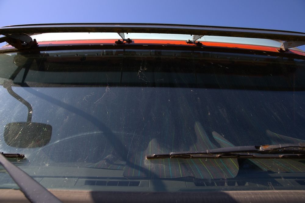 View Through a Car Windshield with Wipers and A Rearview Mirror — Eurobodalla Windscreens in Dalmeny, NSW