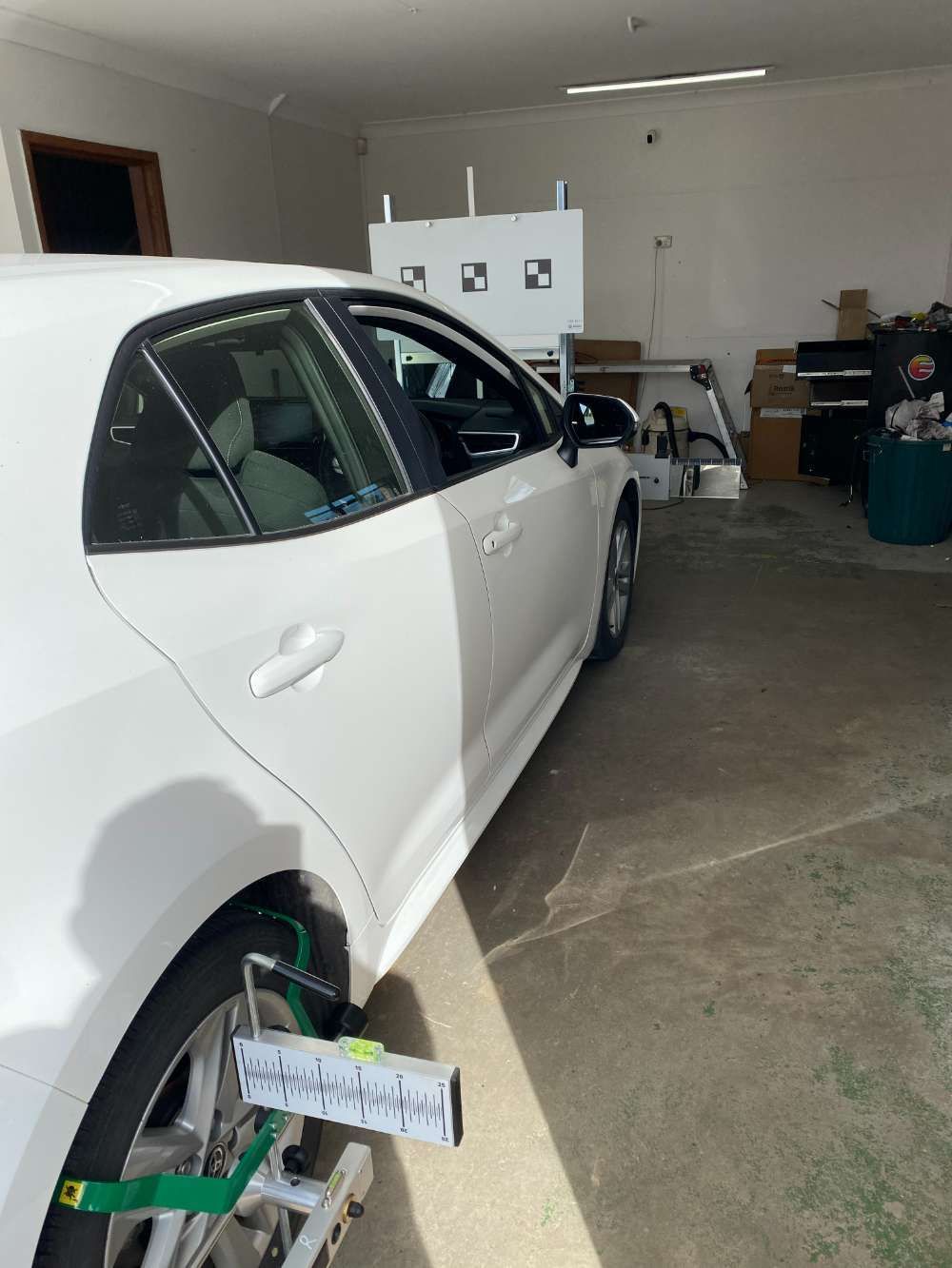 A White Car Is Parked In A Garage — Eurobodalla Windscreens in Moruya, NSW