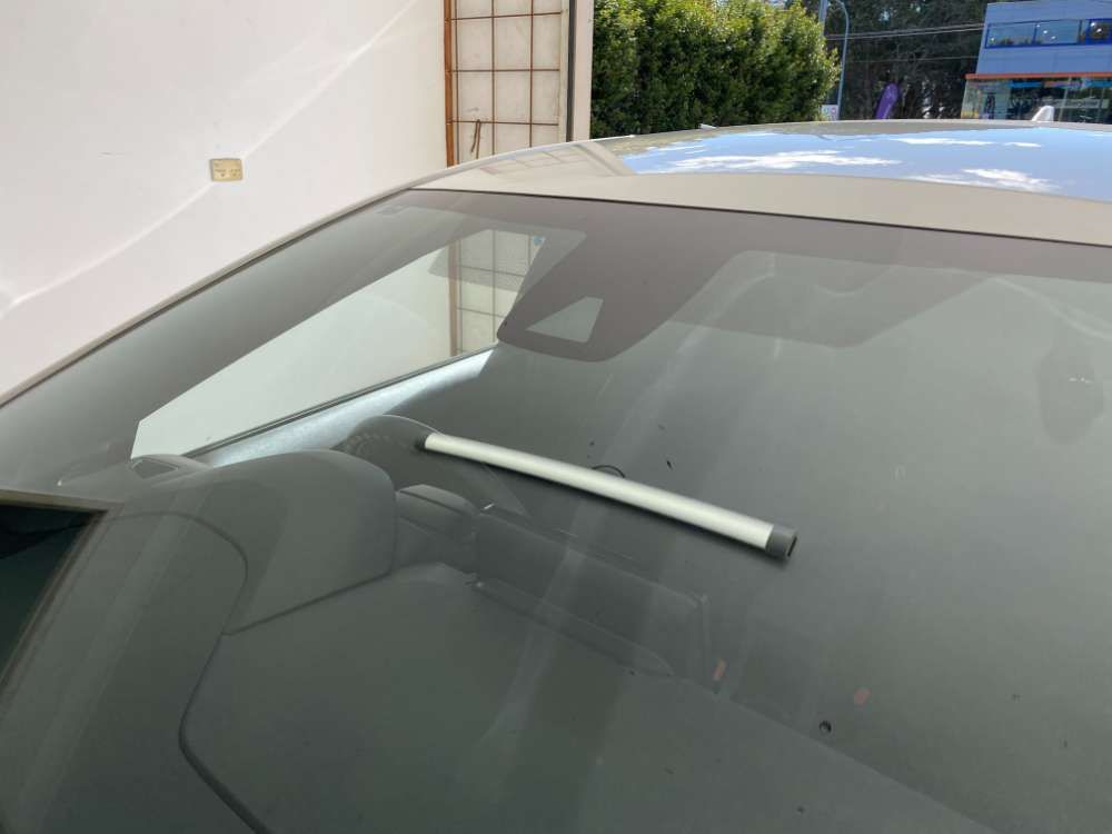 A Close Up Of A Car Windshield With A Wiper Sticking Out Of It — Eurobodalla Windscreens in Moruya, NSW