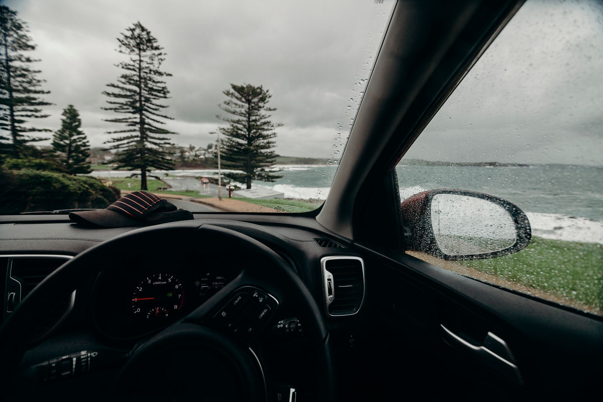 Driver View of A Rainy Coastal Road with Trees — Eurobodalla Windscreens in Dalmeny, NSW