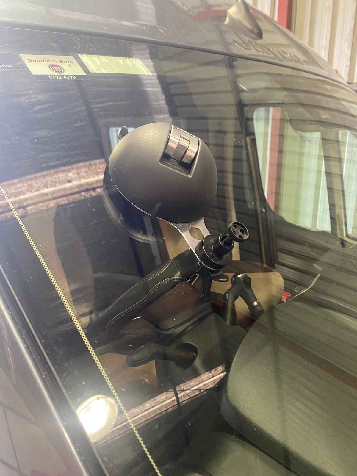 A Person Is Repairing A Car Windshield With A Tool — Eurobodalla Windscreens in Moruya, NSW