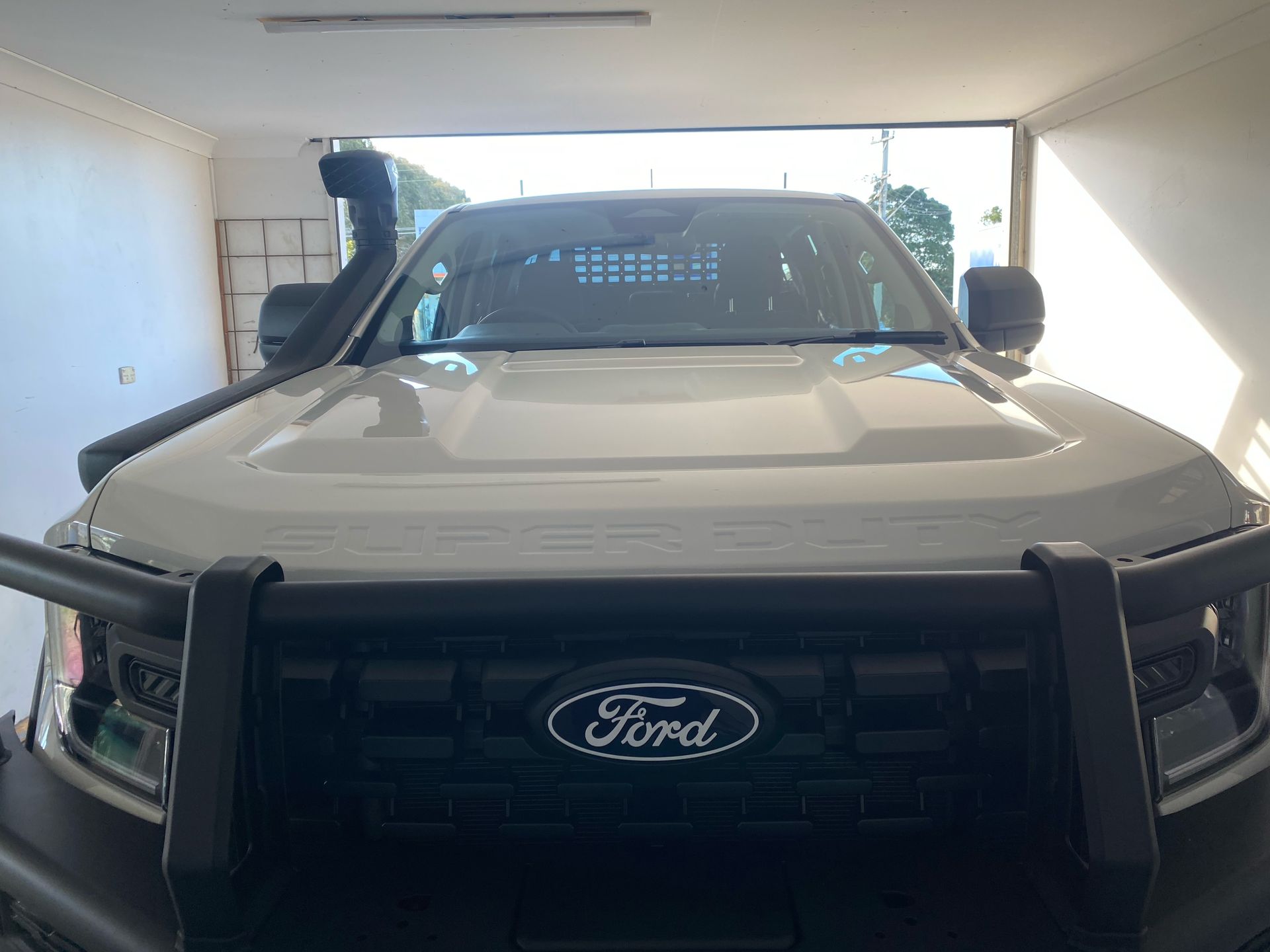 White Ford truck parked inside a garage, viewed from the front. — Eurobodalla Windscreens in Moruya, NSW