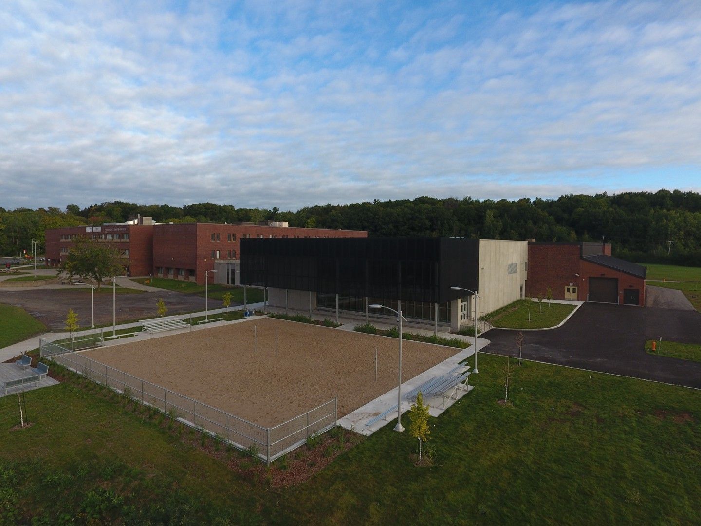 Une vue aérienne d'un terrain de volley-ball devant un grand bâtiment.