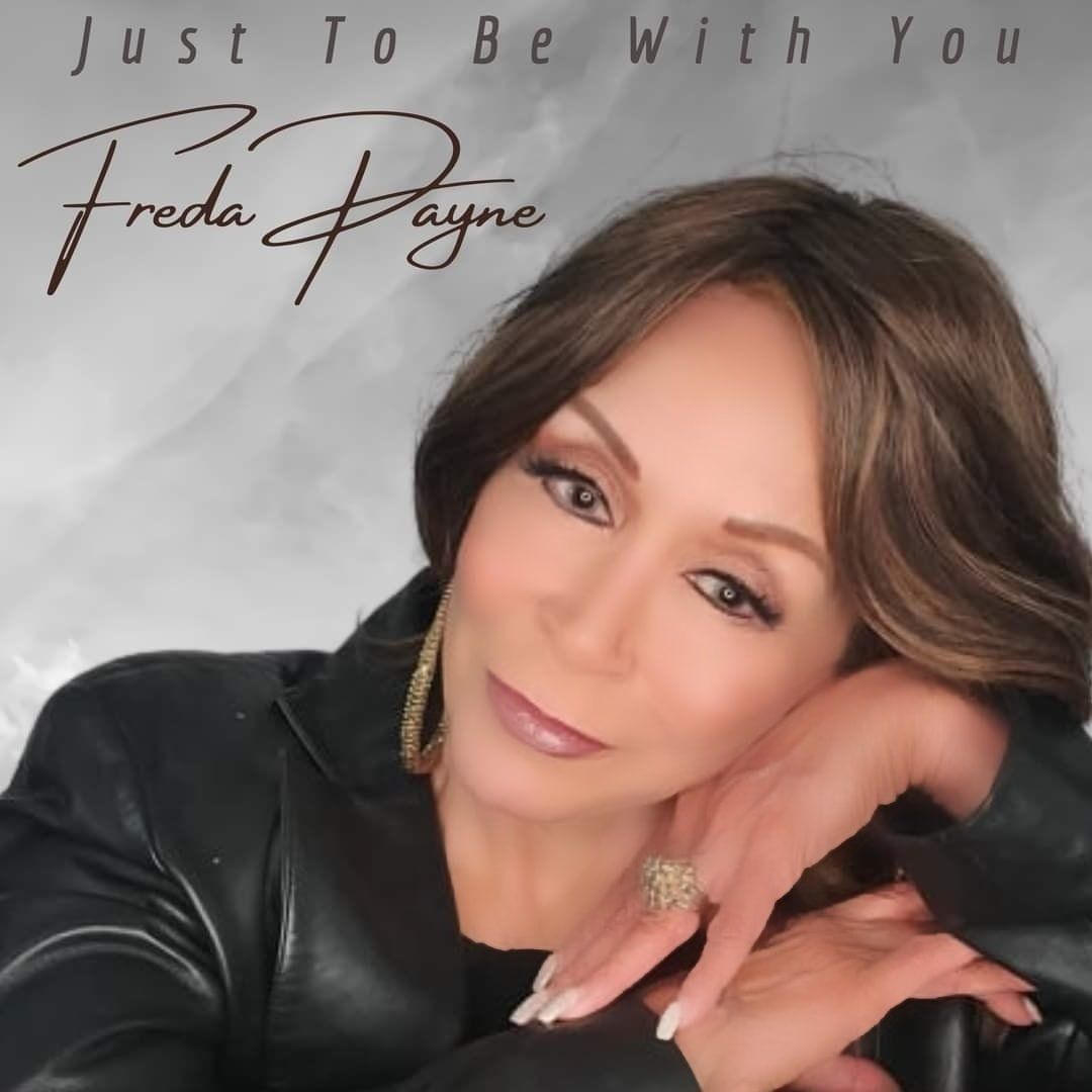 Album cover with a woman in a black jacket, resting her head on her hand, titled “Just To Be With You” by Freda Payne