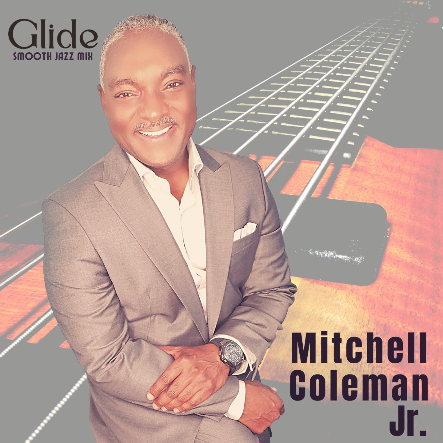 Album cover with a smiling man in a gray suit against a guitar neck background, titled “Glide.”