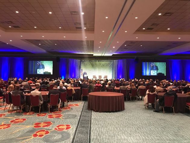 A large room with a lot of people sitting at tables