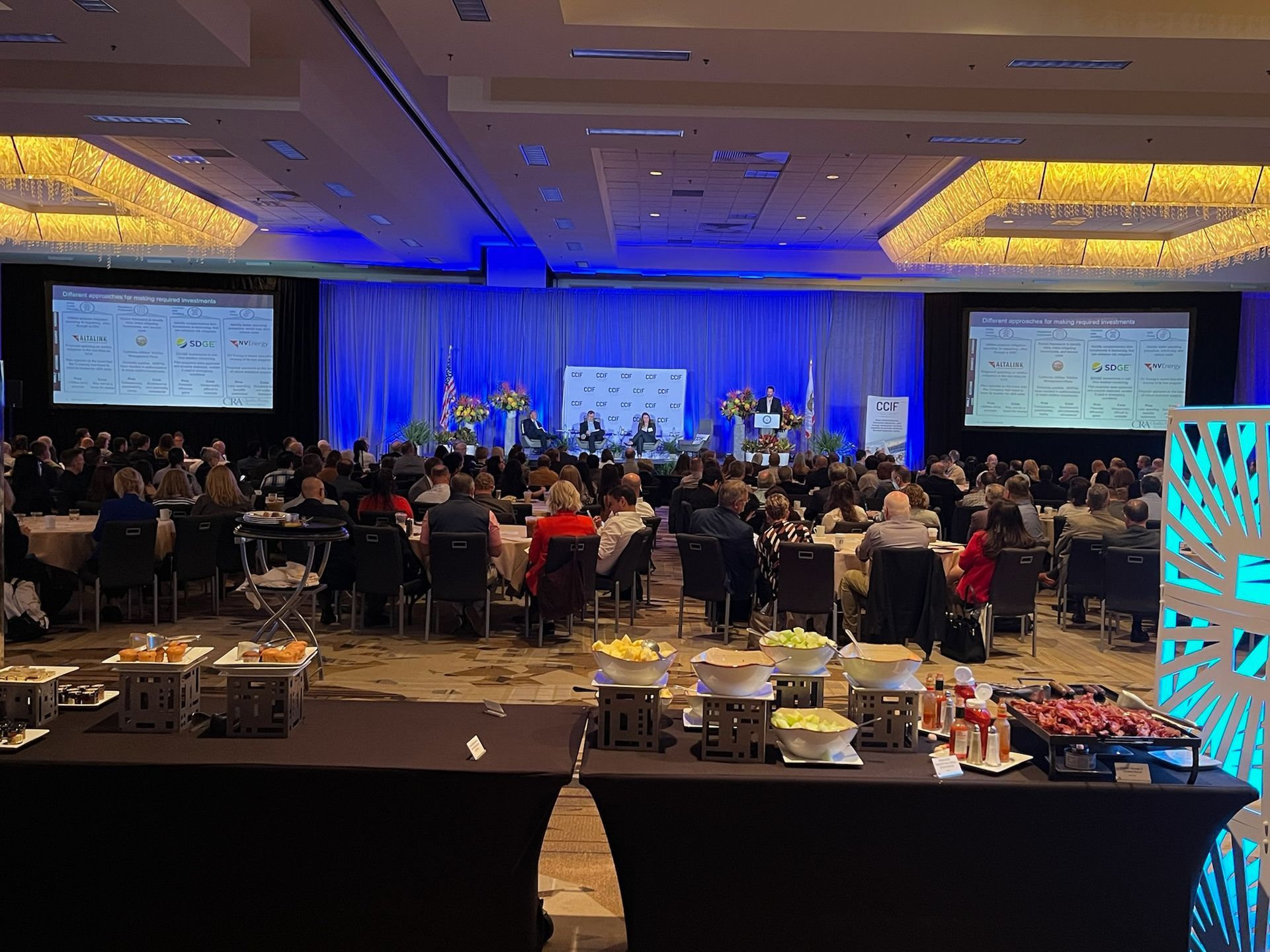 A large room with a lot of people sitting at tables.