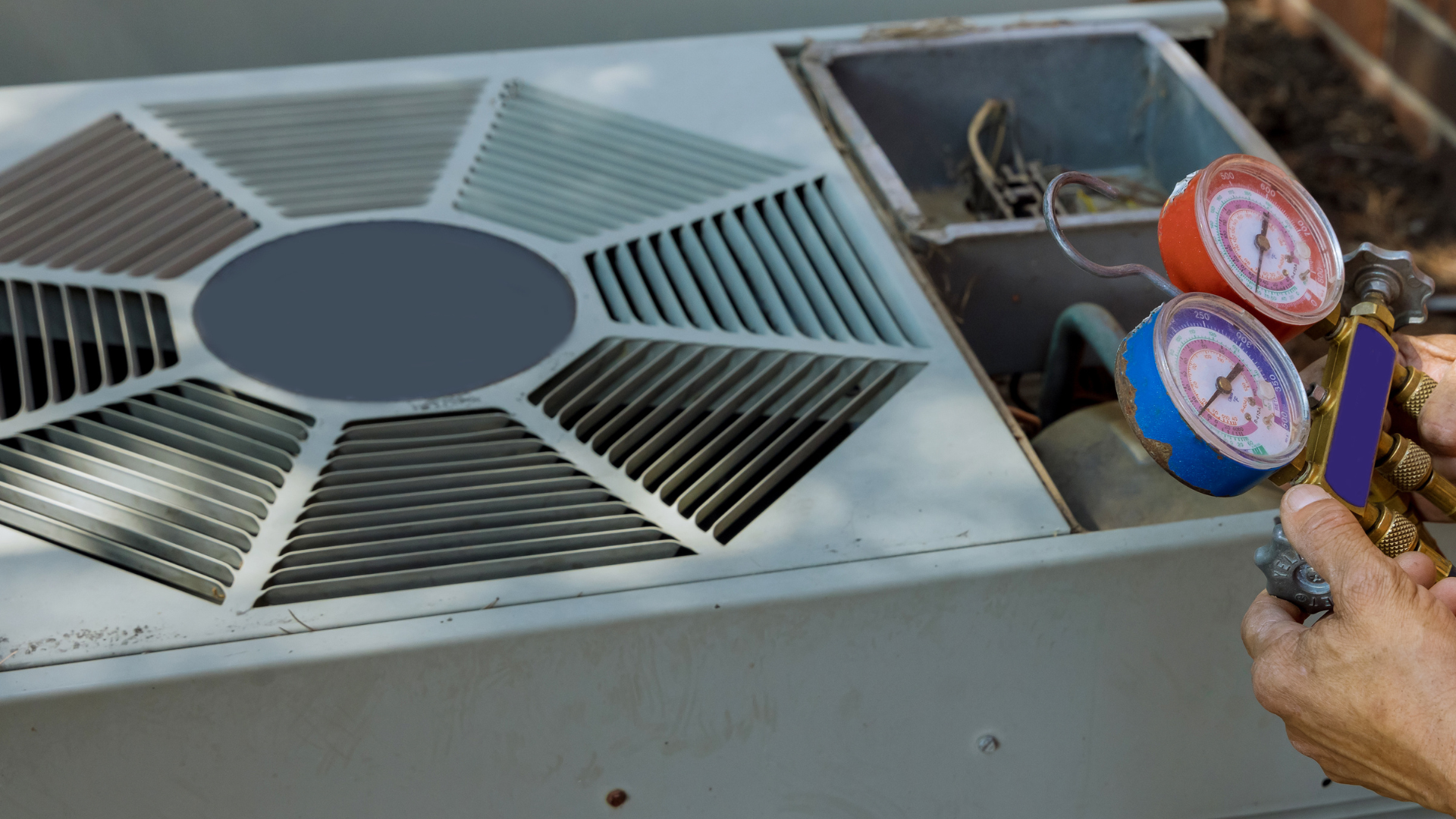 a person is holding a gauge in front of an air conditioner repairing hvac