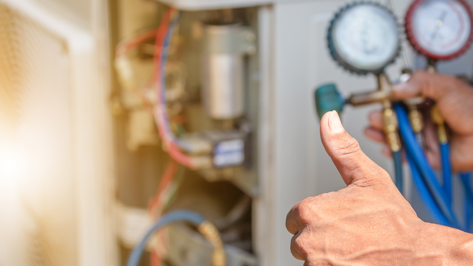 a person is giving a thumbs up while working on an air conditioner