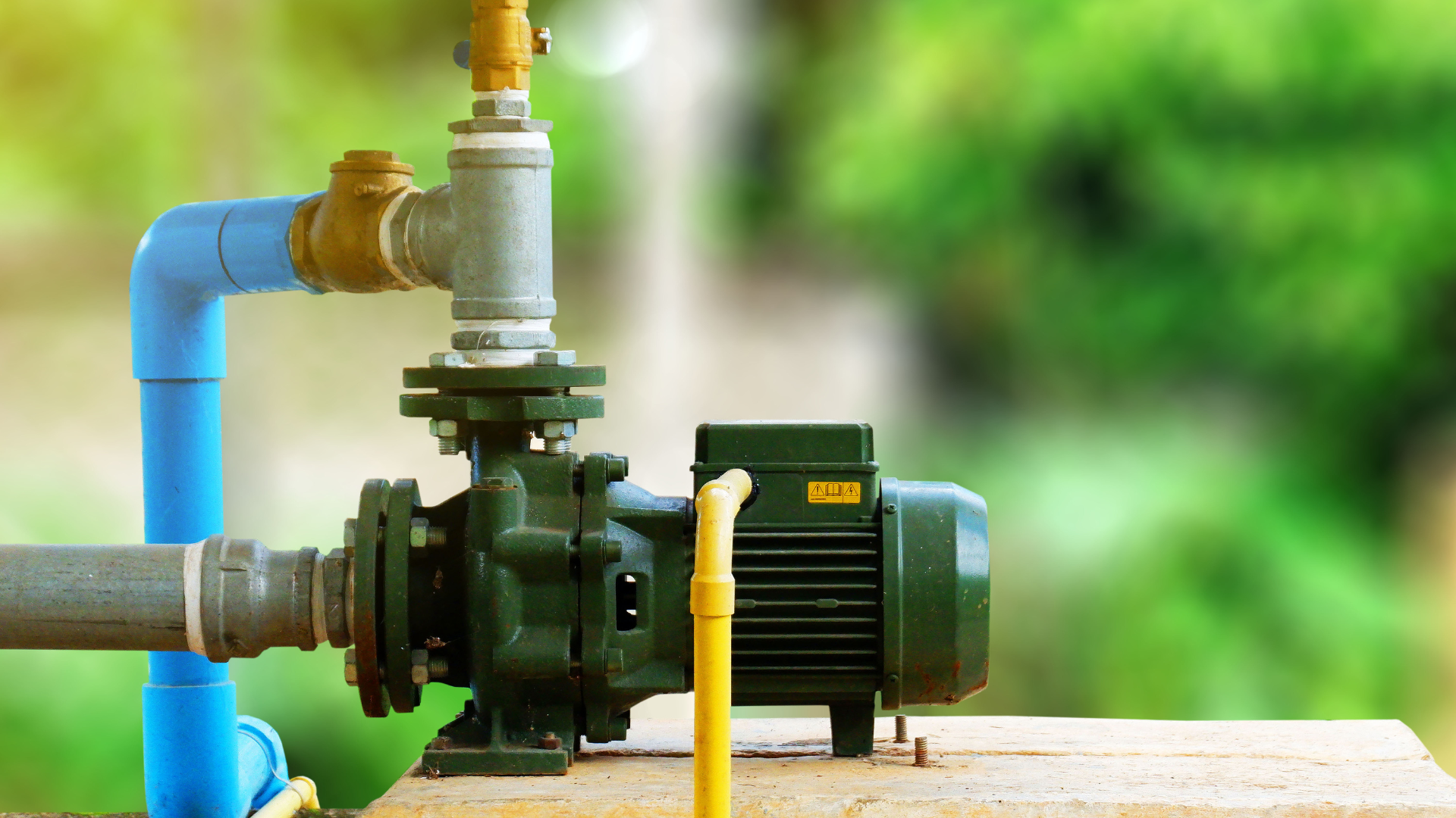 a close up of a water pump with pipes attached to it