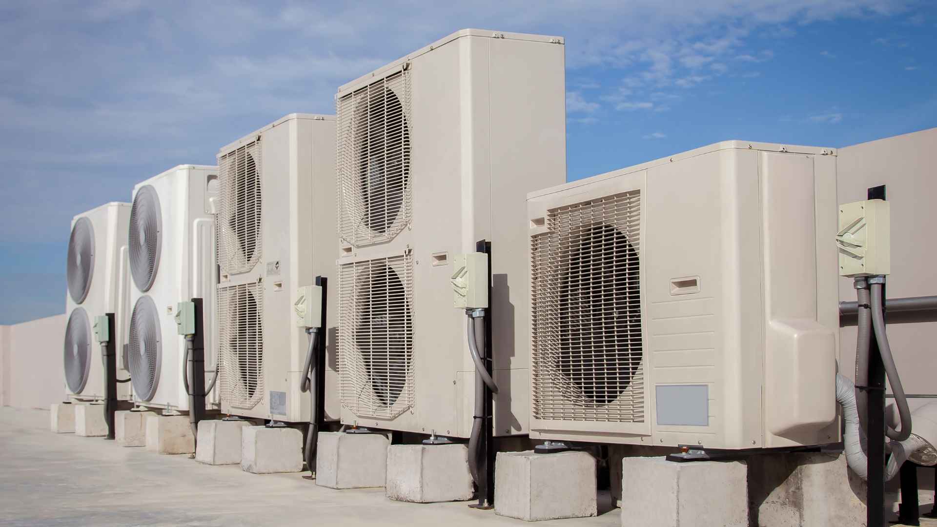a row of air conditioners sitting on top of a building