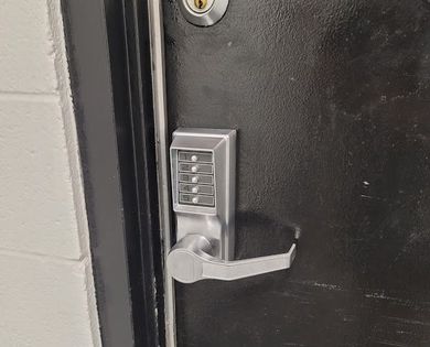 Locks Keys and More | A close up of a door with a digital lock on it.