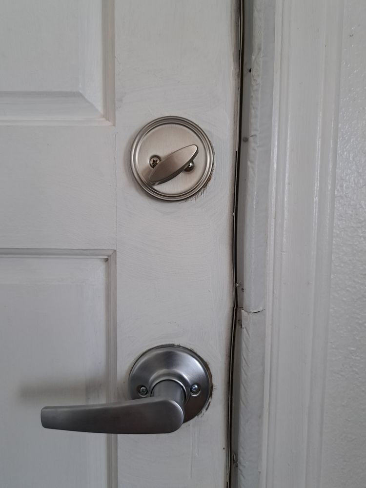 Locks Keys and More | A close up of a door lock on a white door.