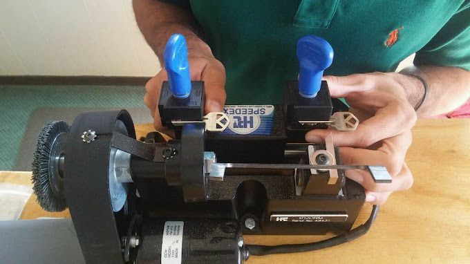 Locks Keys and More | A man in a green shirt is using a key machine