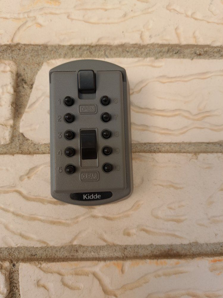 Locks Keys and More | A key safe is mounted on a brick wall
