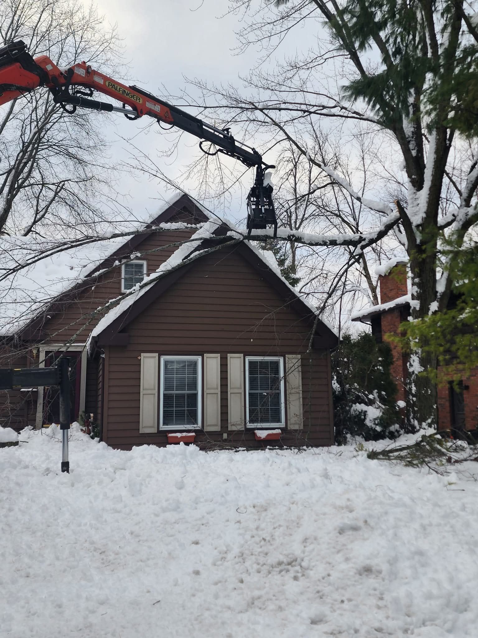 A snowy house with a crane on top of it