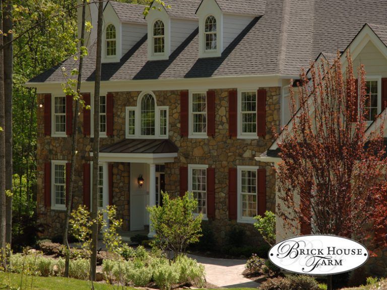 A large brick house with a sign that says brick house farm
