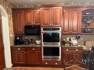 A kitchen with wooden cabinets and stainless steel appliances.