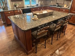 There is a large island in the middle of the kitchen.