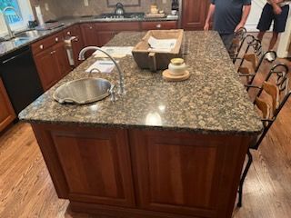 A kitchen with a large island and a sink.
